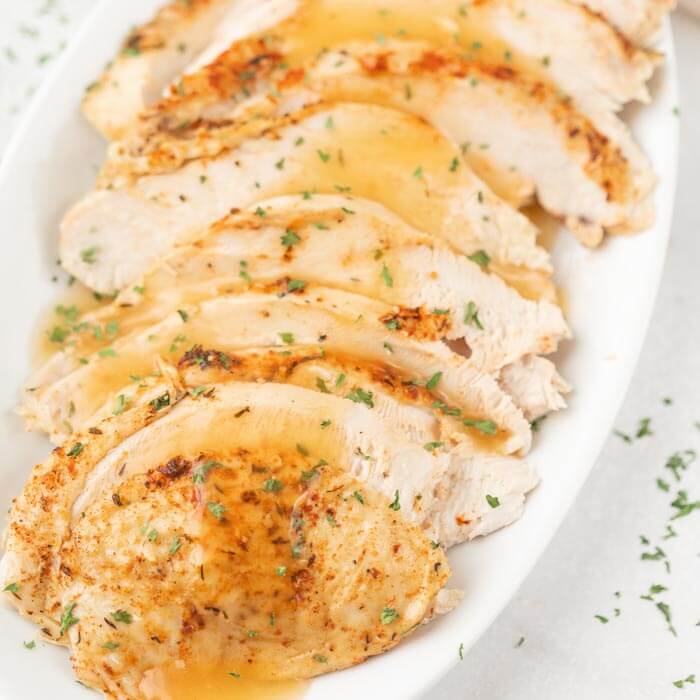 sliced turkey breast with gravy on platter