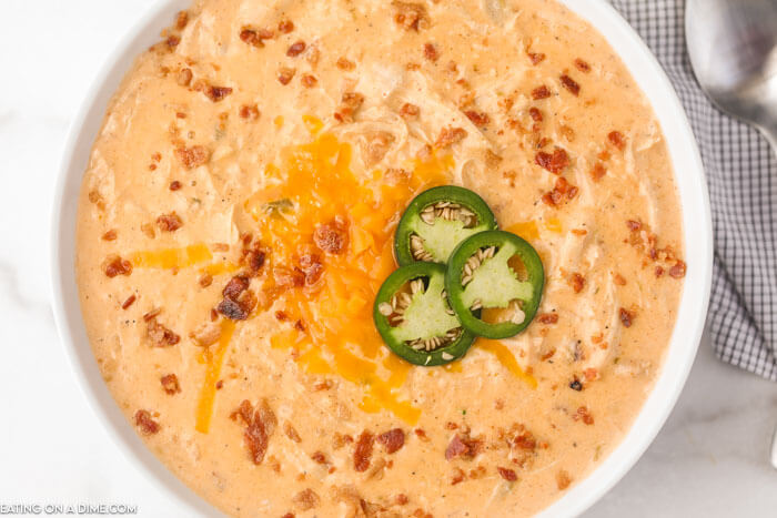 Close up image of a white bowl of Jalapeno Popper Chicken Soup. 