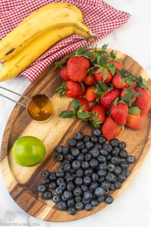 Ingredients needed - banana, fresh strawberries, blueberries, lime and honey