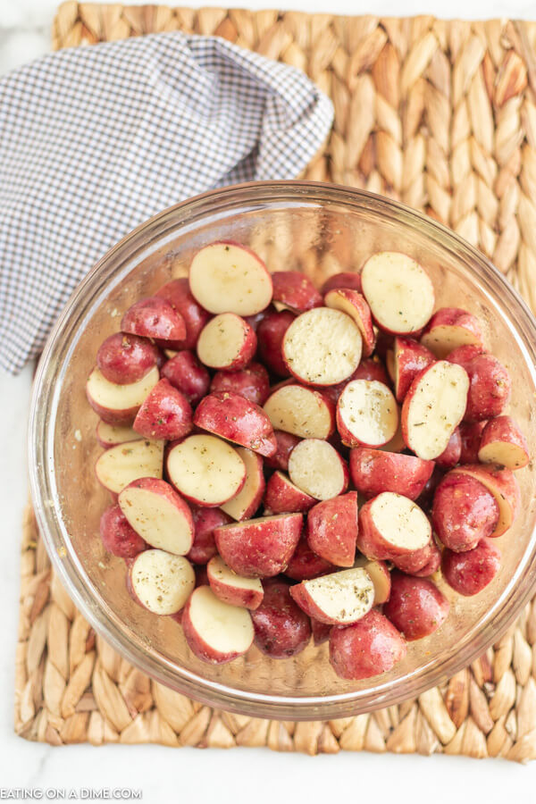 Cut and seasoned red potatoes in mixing bowl. 