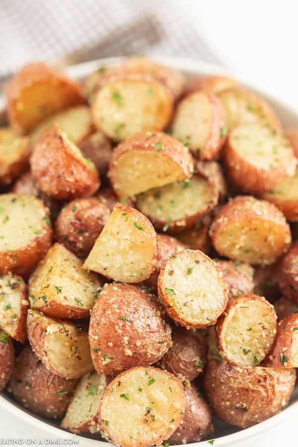 Serving dish of roasted red potatoes.