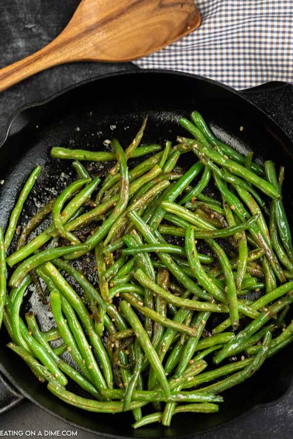 Skillet with cooked green beans. 