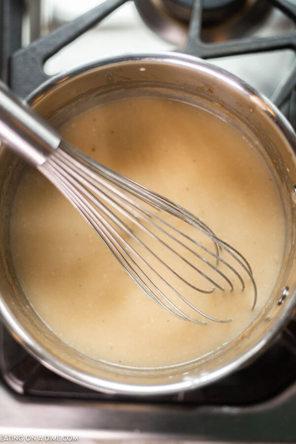 Then the drippings or broth being whisked into the roux 