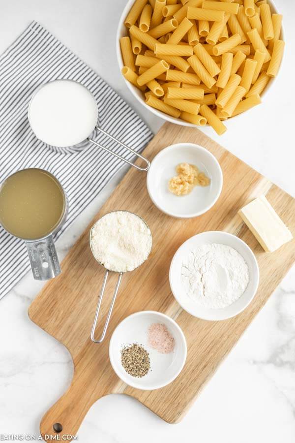 Ingredients for recipe: pasta, milk, chicken broth, garlic, flour, parmesan cheese, spices, butter.