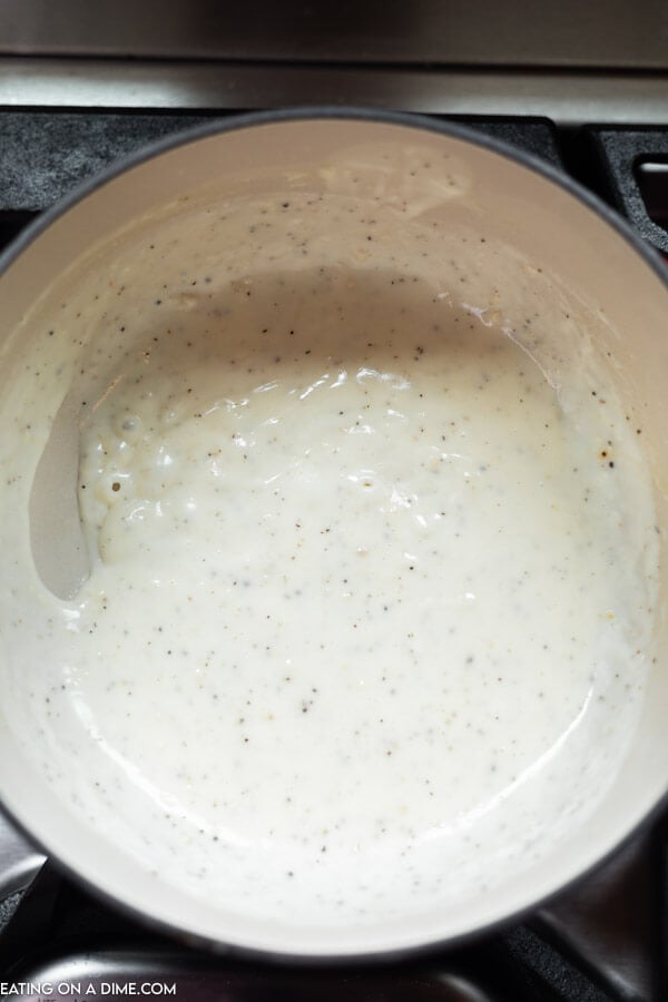 Cream sauce being made in pan.