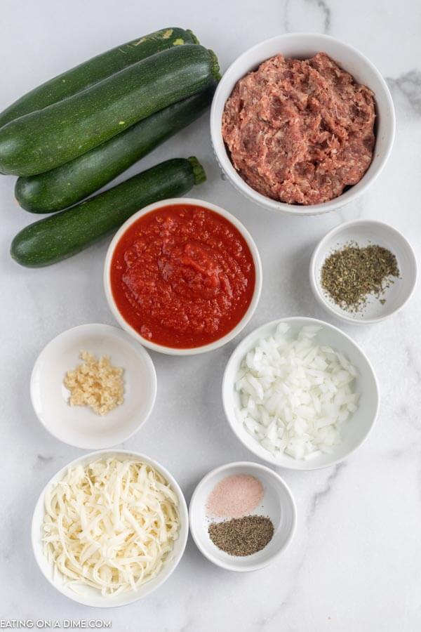 Ingredients for recipe: zucchini, Italian sausage, crushed tomatoes, Italian seasoning, onion, cheese, garlic. 