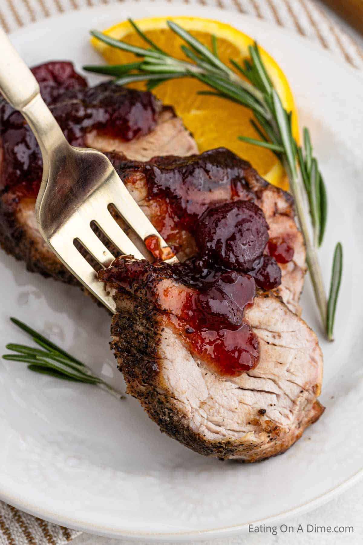 Close up image of slice cranberry pork tenderloin on a platter