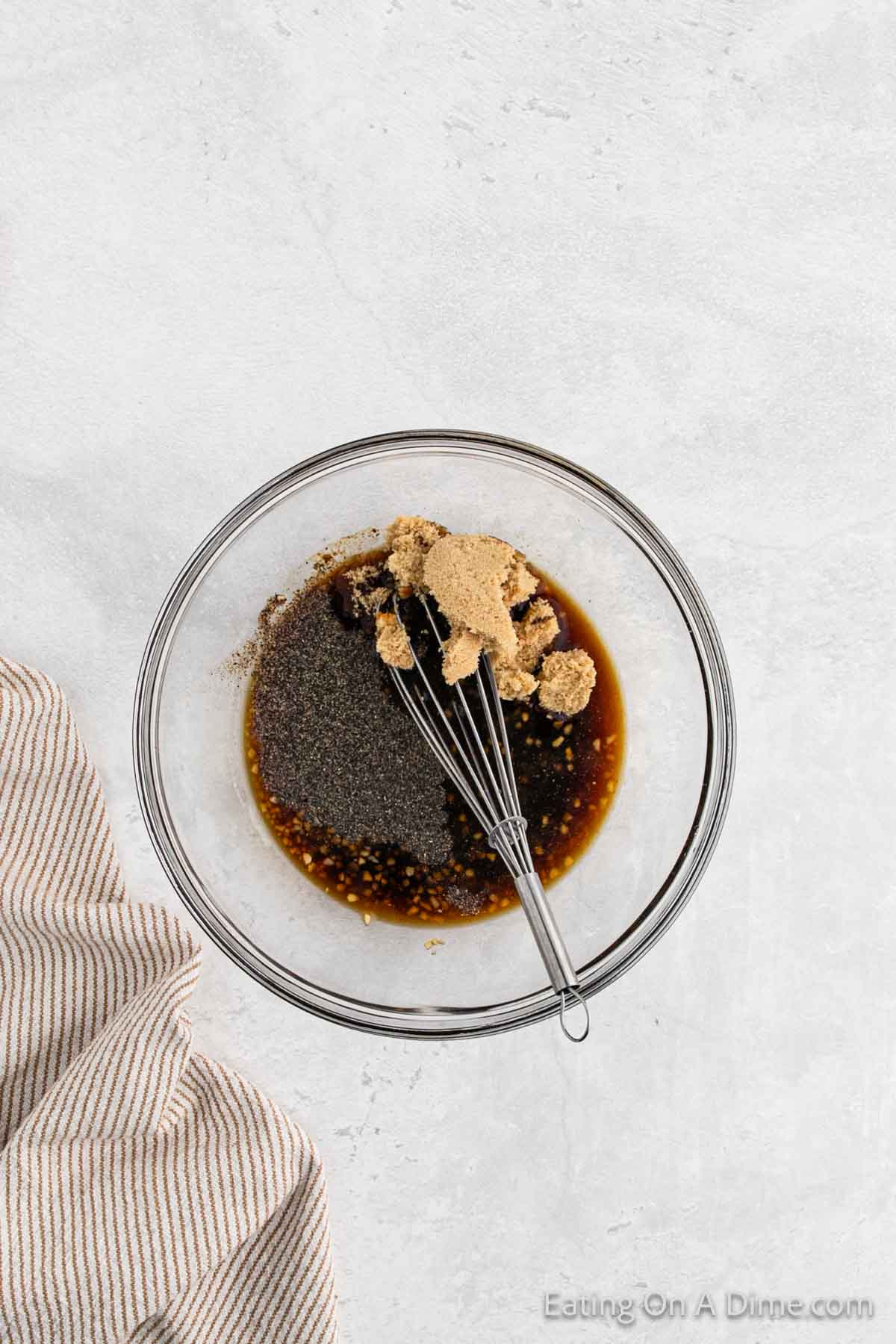 Whisking the marinade ingredients in a bowl