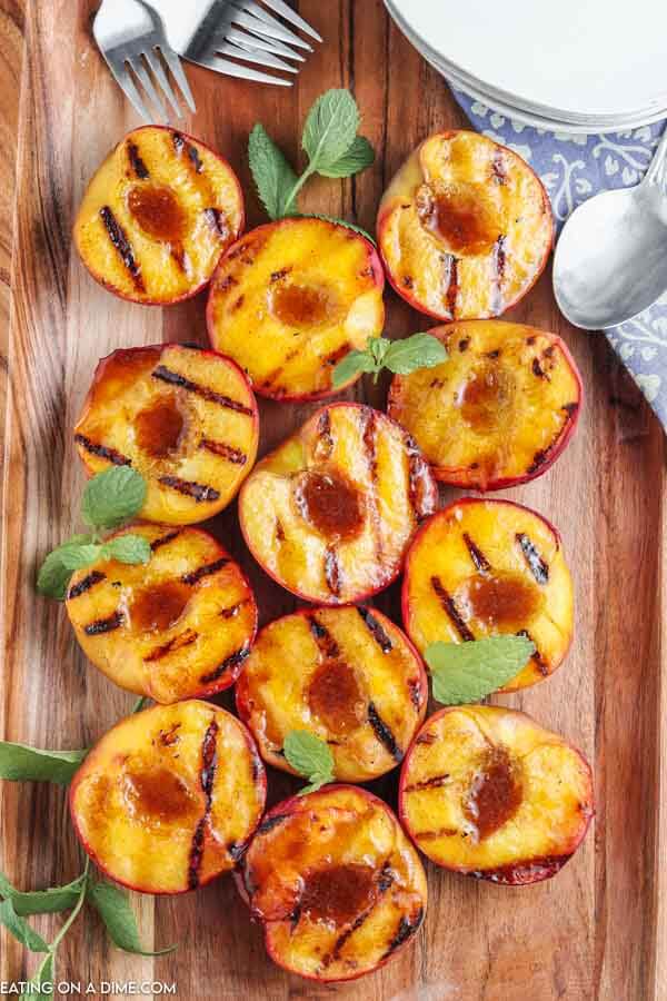 grilled peaches on cutting board