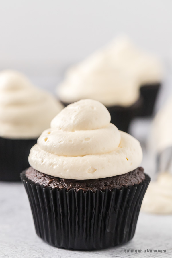 Close up image of chocolate cupcake with marshmallow fluff frosting. 