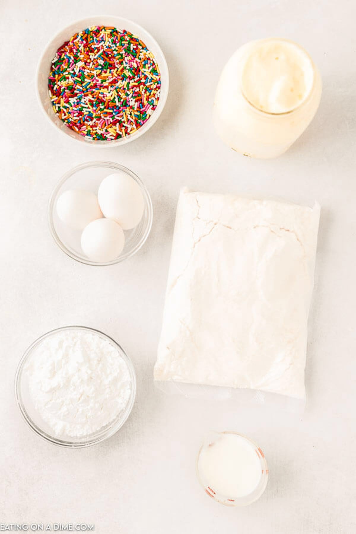 Ingredients for Melted Ice Cream Cake: white cake mix, melted ice cream, eggs, confectioner's sugar, milk, sprinkles