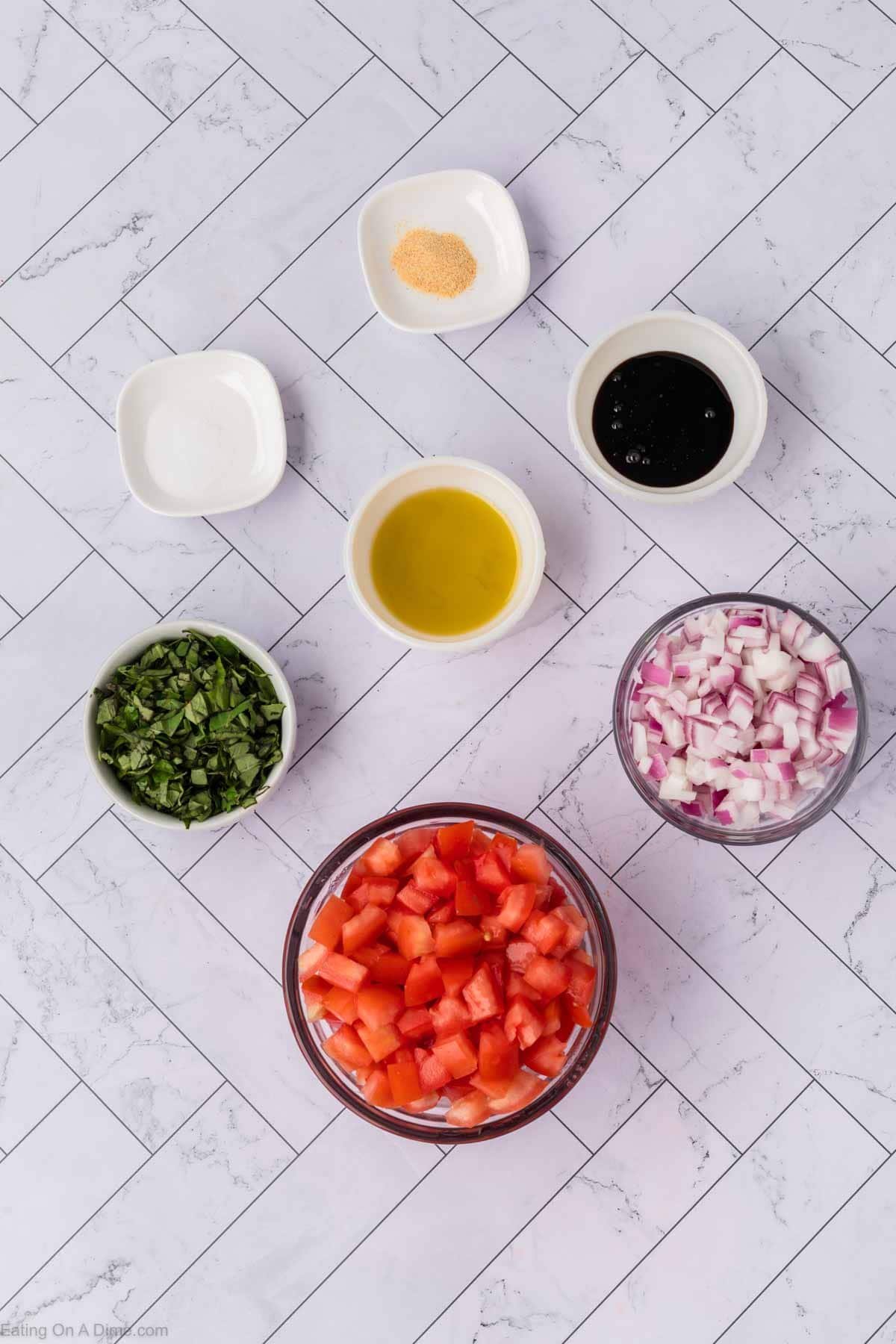 Ingredients - roma tomatoes, red onion, fresh basil, olive oil, garlic powder, balsamic glaze