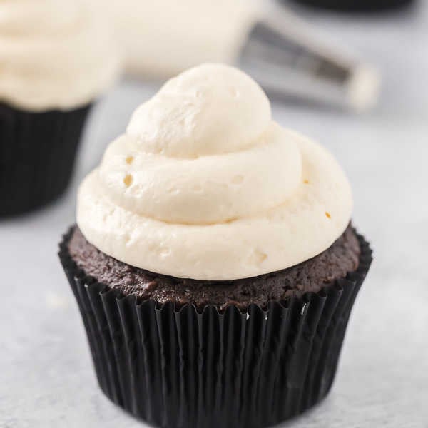 Close up image of chocolate cupcake with marshmallow fluff frosting. 