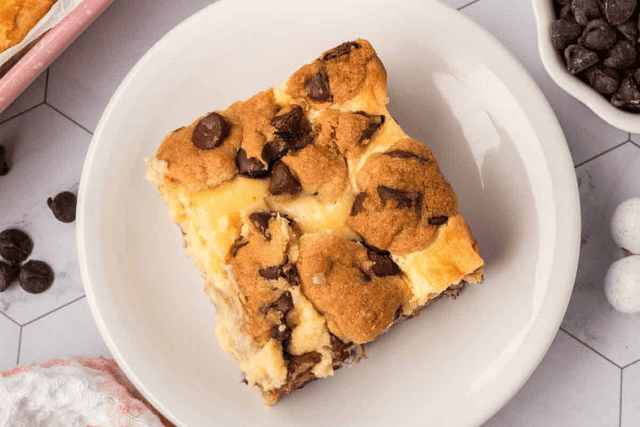 Chocolate Chip Cheesecake Bars cut into square on a plate. 