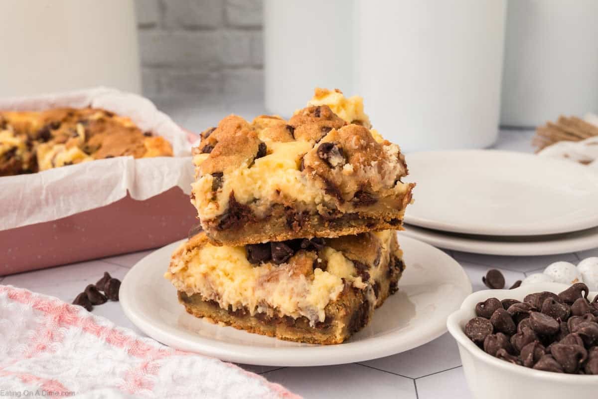 Chocolate Chip Cookie Cheesecake bars stacked on a plate