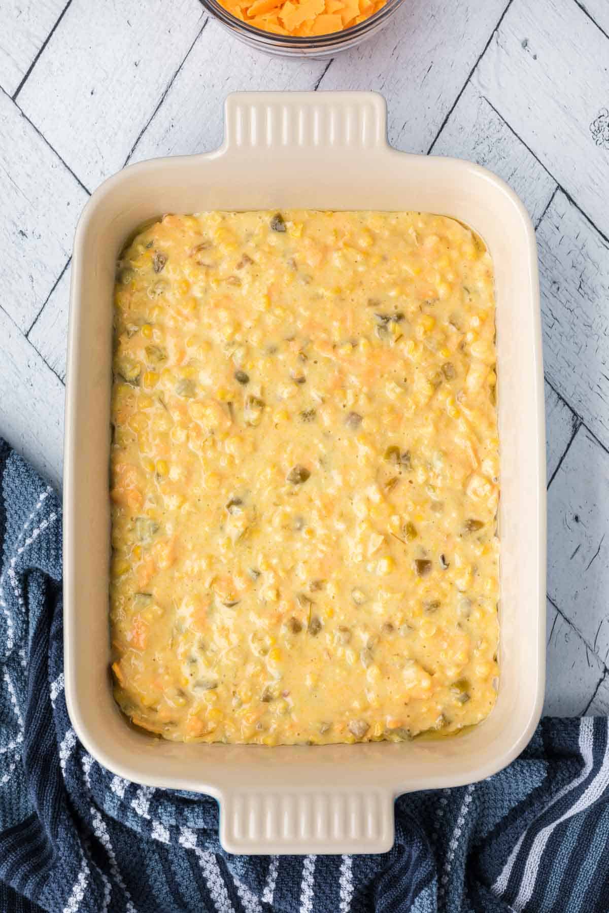 Spreading the corn casserole into the baking dish