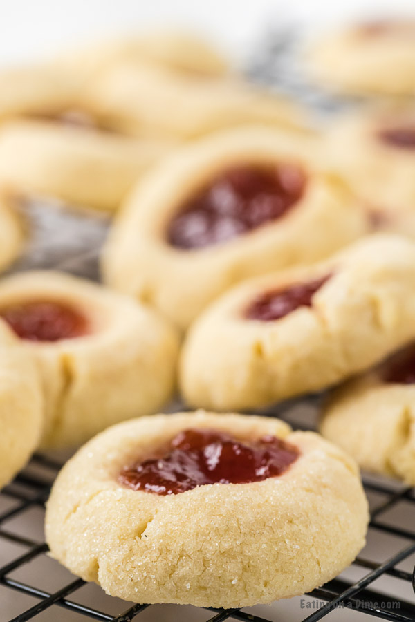 Close up image of Thumbprint Raspberry cookies on a cooling rack. 