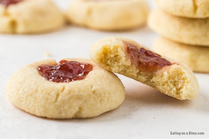 Close up image of Thumbprint Raspberry cookies stacked. 