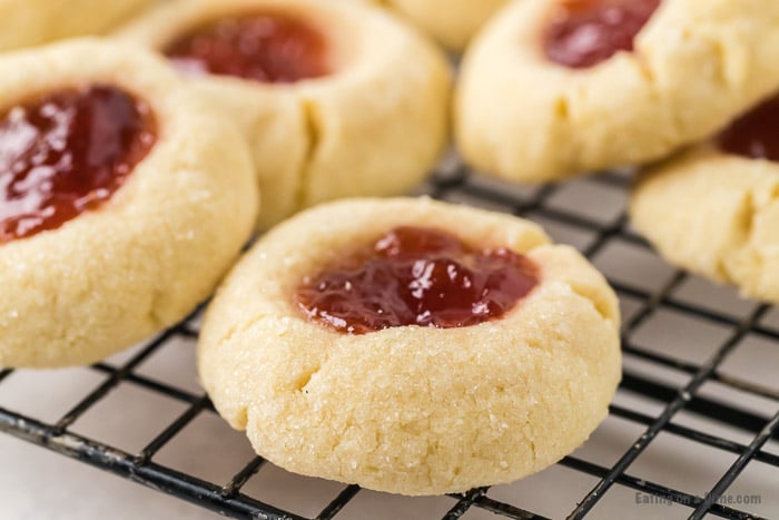 Close up image of Thumbprint Raspberry cookies on a cooling rack. 