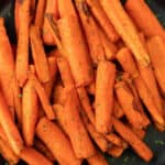 Air fryer carrots on a black plate ready to serve.