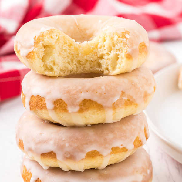 Close up of glazed bake donuts stacked. 