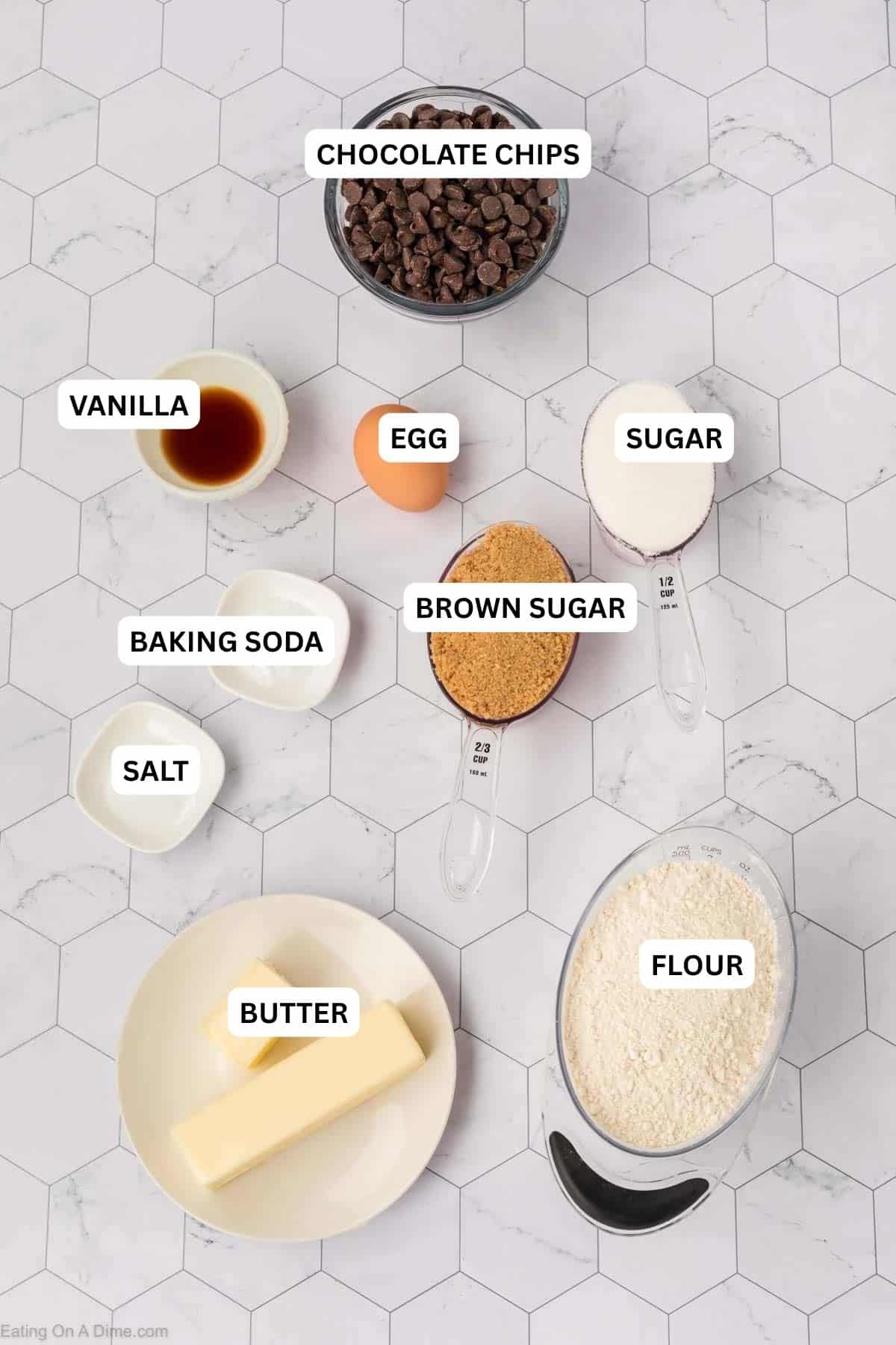 Ingredients for recipe: chocolate chips, vanilla, egg, sugar, baking soda, brown sugar, salt, butter and flour.