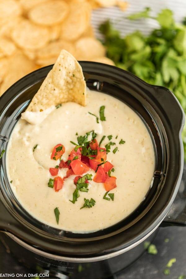 This crock pot white cheese dip recipe is easy to make and everyone loves it. A restaurant quality white Mexican queso blanco dip recipe that you can make at home. This homemade Mexican white cheese dip without velveeta is better than the ones from Mexican restaurants. It’s one of my favorite dip recipes. #eatingonadime #diprecipes #whitecheesedip crock pot of queso dip.