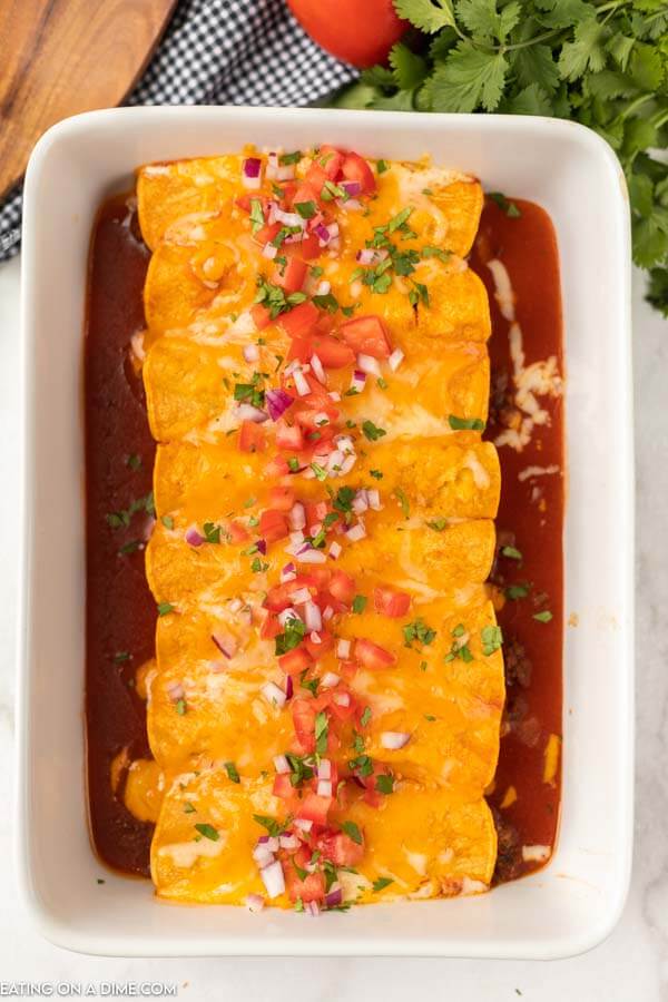 Make this Easy Ground Beef Enchiladas Recipe when you need a quick but delicious dinner idea. Get all the flavors of enchiladas in just minutes. casserole dish of enchiladas
