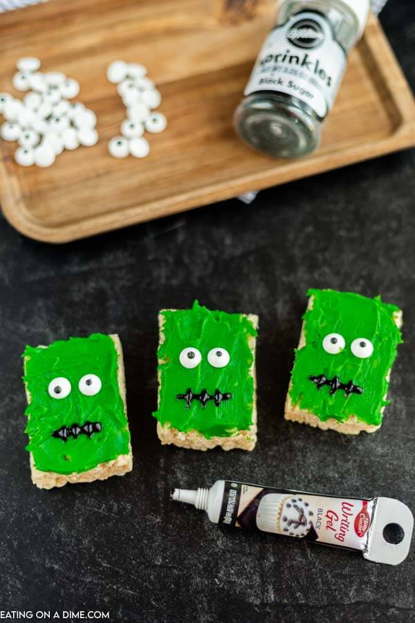 green icing and candy eyes on rice krispies for a halloween treat