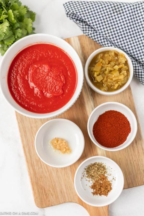 Ingredients for Red Enchilada Sauce - Tomato Sauce, Green Chilies, Chili Powder, Cumin, Dried Oregano, Minced Garlic