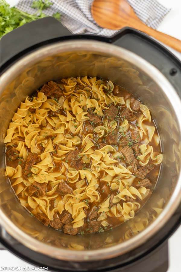 Soup in pressure cooker with noodles added. 