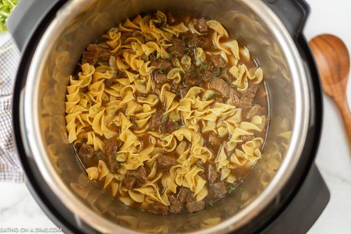 Soup in pressure cooker after adding noodles. 