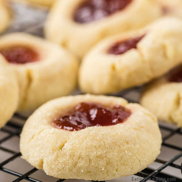 Close up image of Thumbprint Raspberry cookies on a cooling rack. 