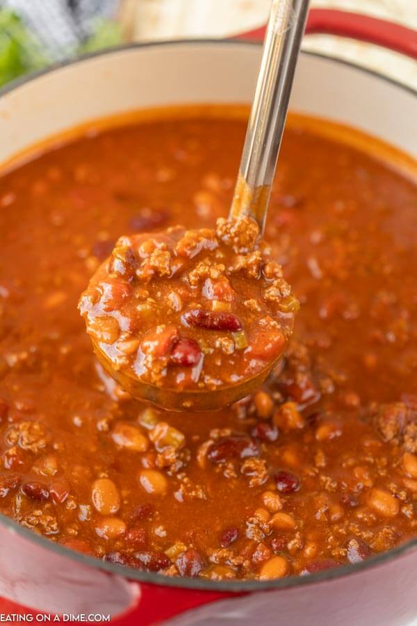Close up image of wendy's chili with a serving spoon of chili on it. 