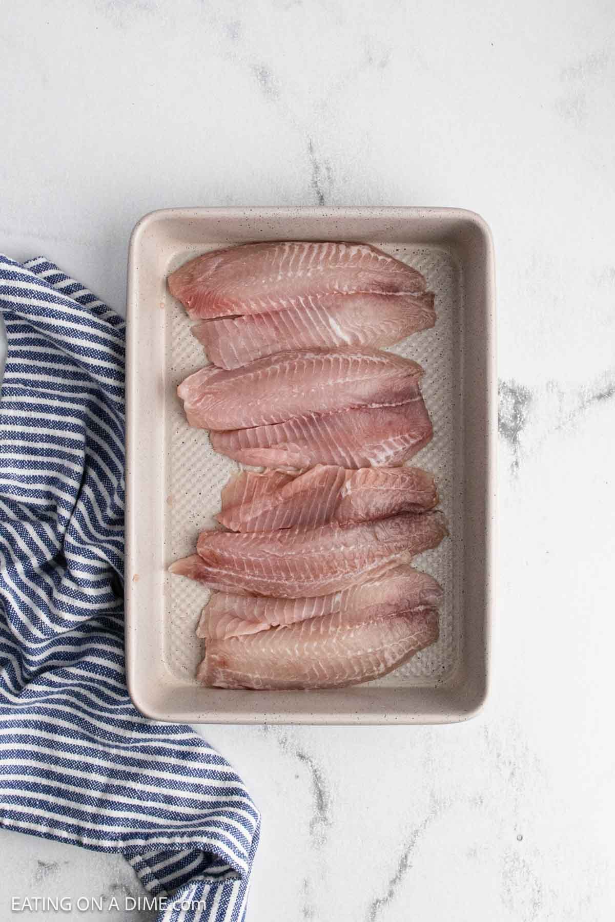 Fish placed in a baking dish.