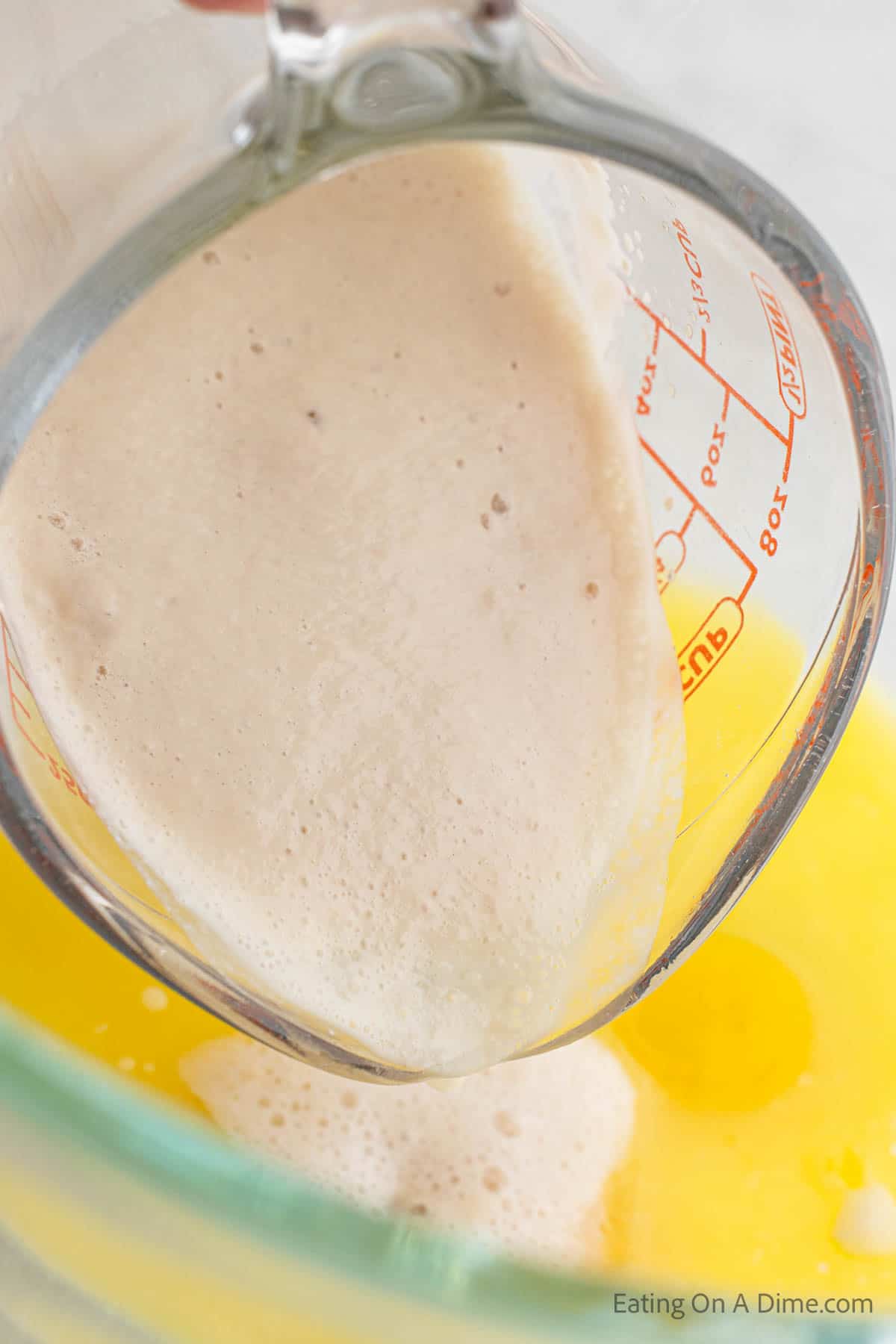 Pouring yeast into egg