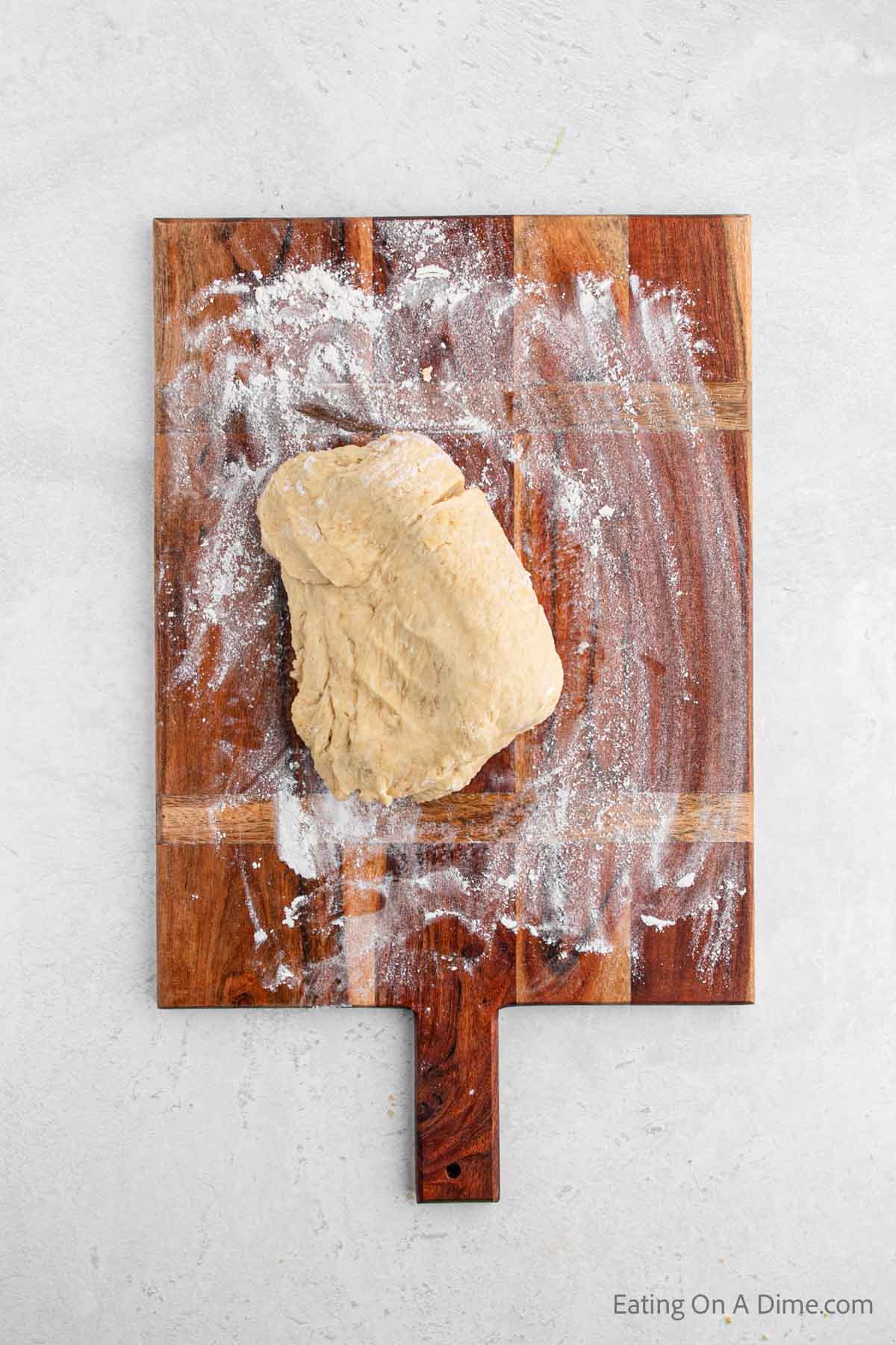 Dough on a floured surface cutting board