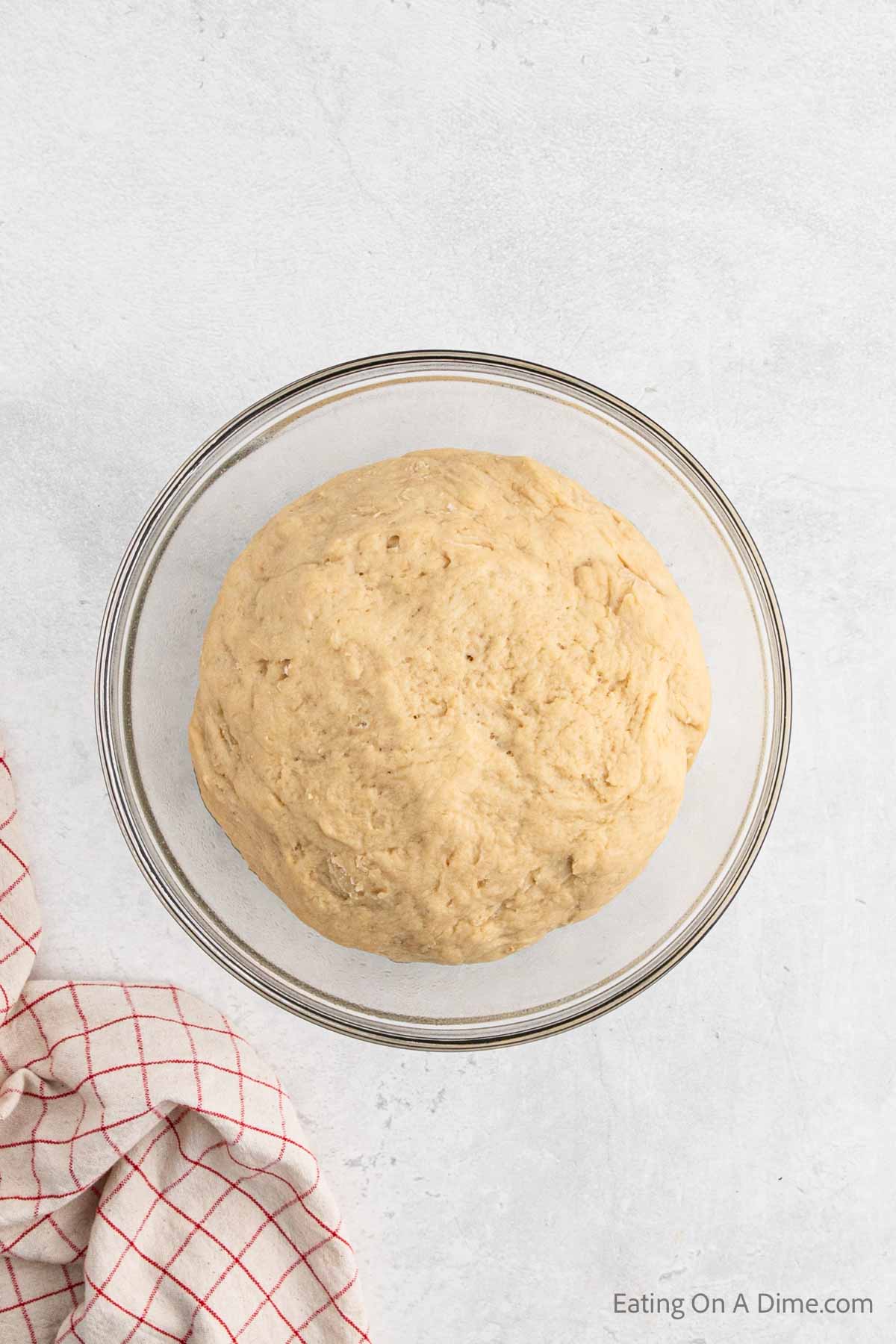 Dough ball doubled in size in a bowl