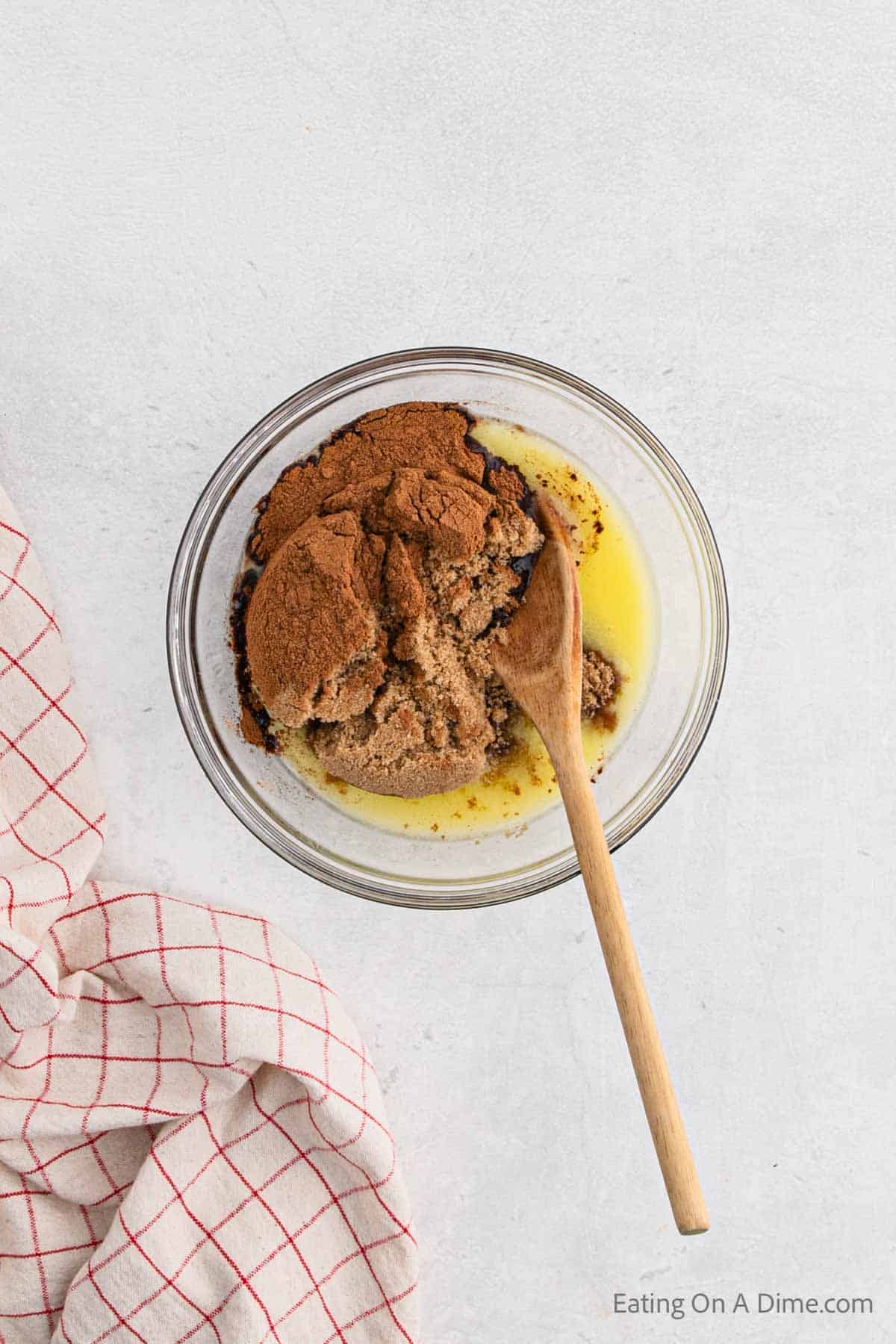 Combining the cinnamon sugar filling in a bowl with a wooden spoon