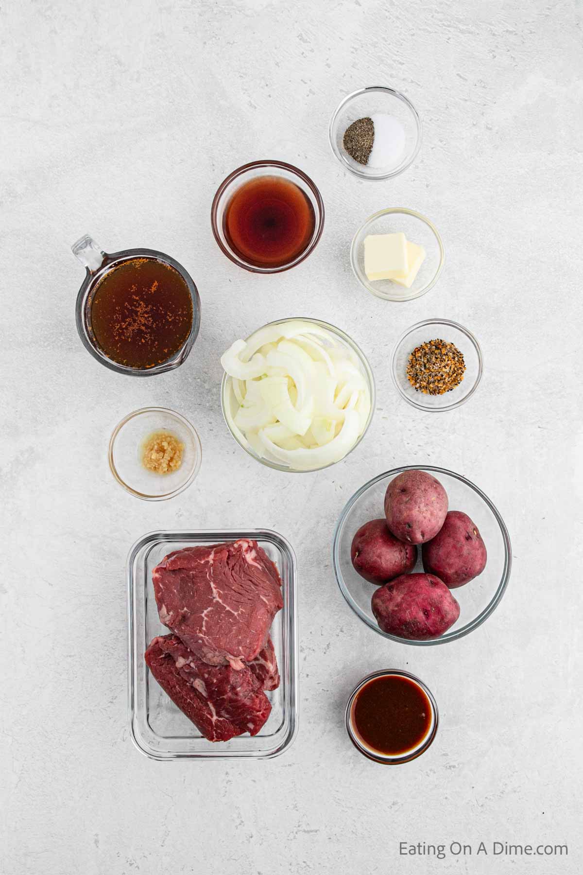 Instant pot steak ingredients - round steak, red wine vinegar, a1 sauce, onion, steak seasoning, beef stock, red potatoes, minced garlic, salt, pepper, butter