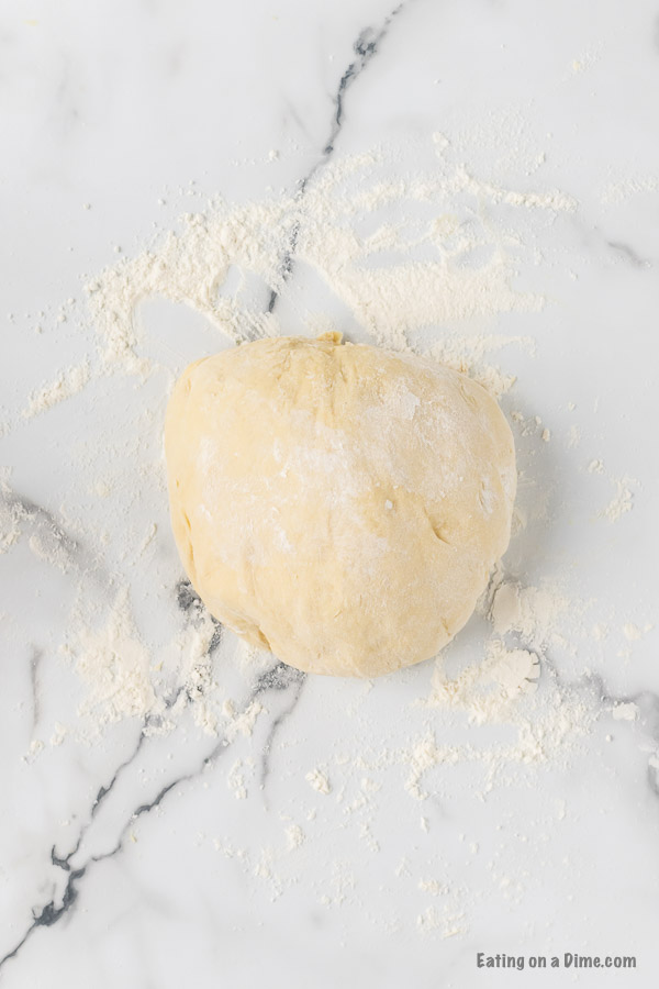 Kneaded dough ball on a floured surface
