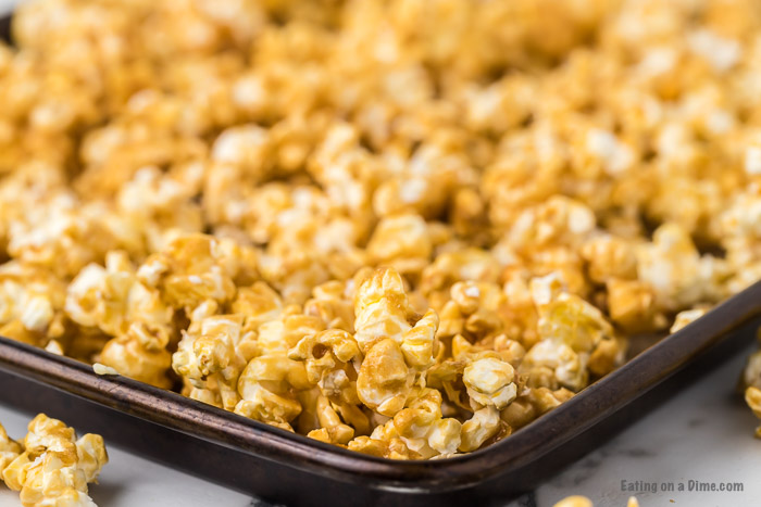 Close up image of a caramel popcorn on a cookie sheet. 