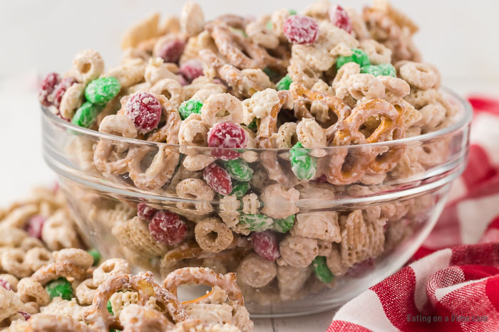 Close up image of Christmas Chex in a clear bowl. 