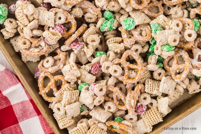 Close up image of Christmas Chex Mix in a baking sheet. 
