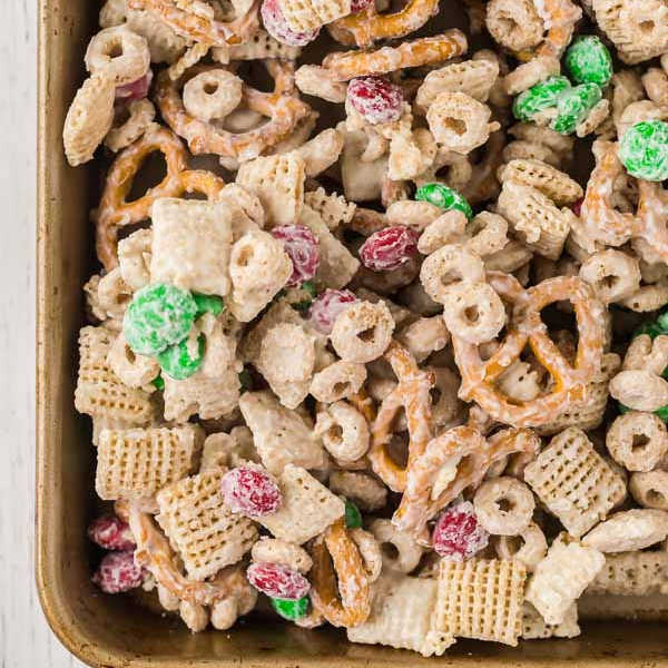 Close up image of Christmas Chex Mix on a baking sheet. 