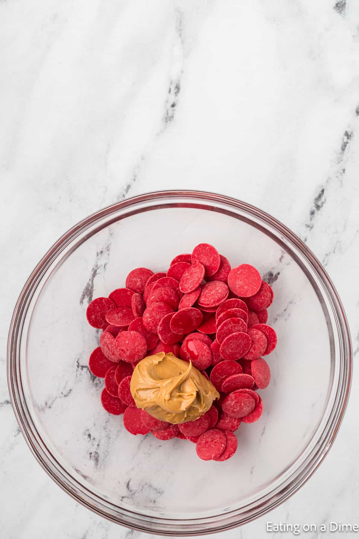 Red Candy Melts with peanut butter in a bowl