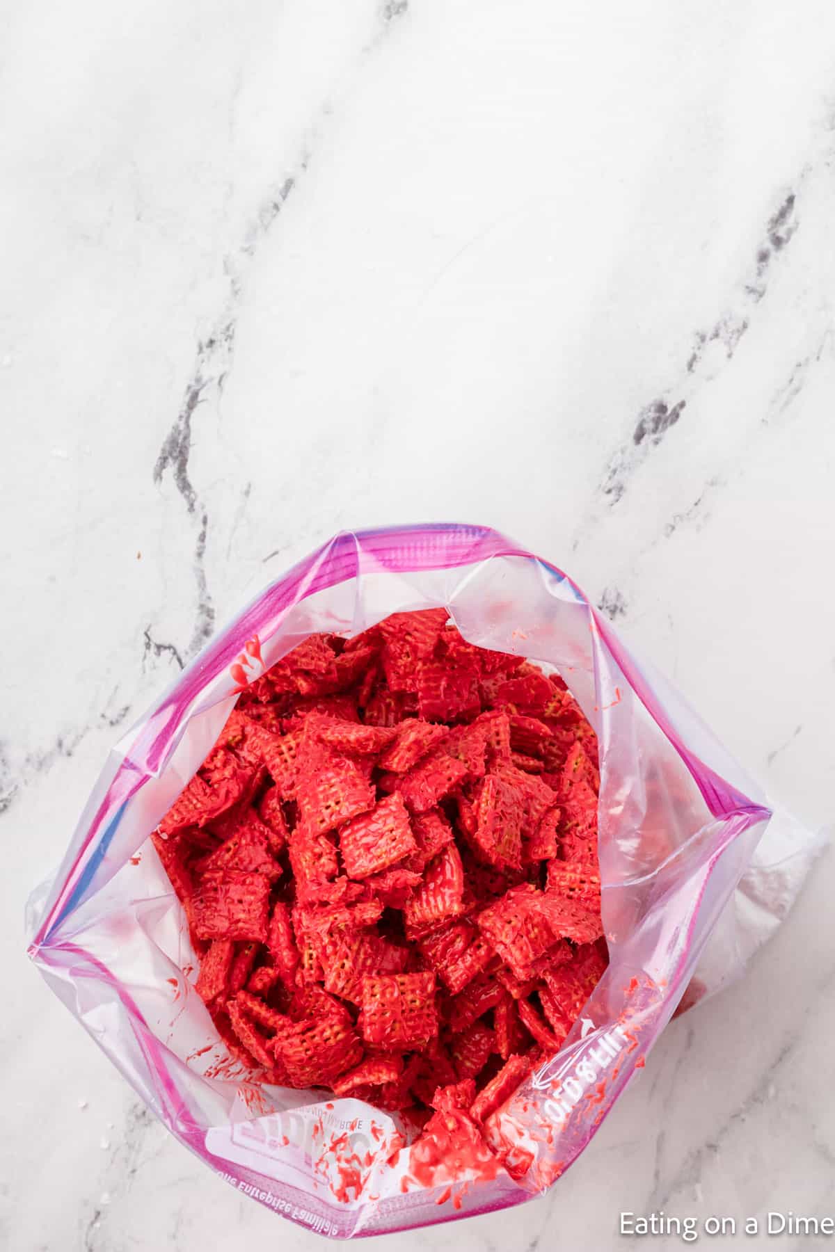Red Coated Chex Cereal in a zip lock bag
