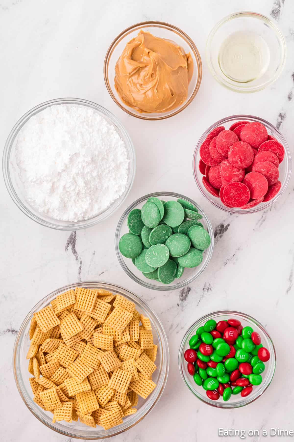 Powdered sugar, Chex Cereal, red and green candy melts, peanut butter, oil, and red and green M&M's. 