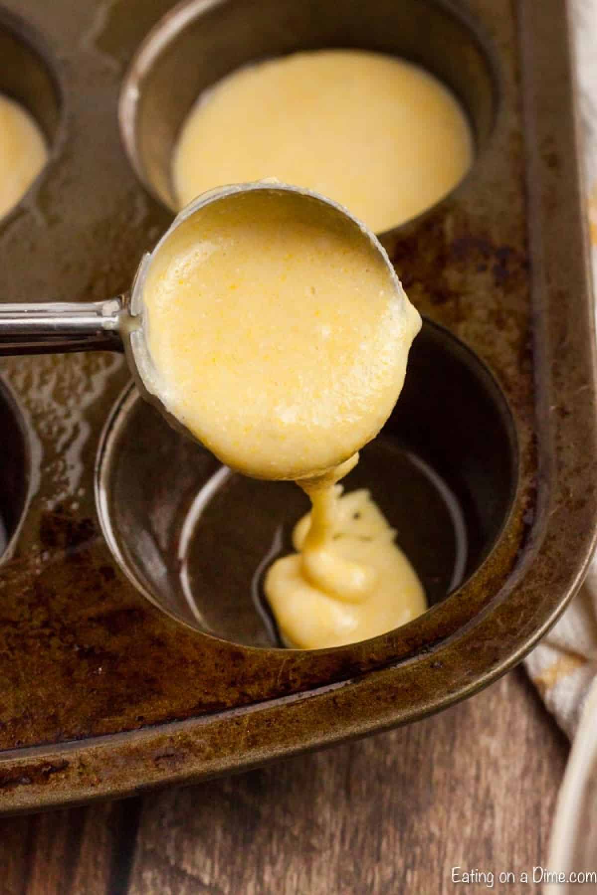 Cornbread Muffins are just so easy to make and much better than those store bought mixes. This cornbread muffin recipe is delicious and a family favorite. batter going into muffin pan