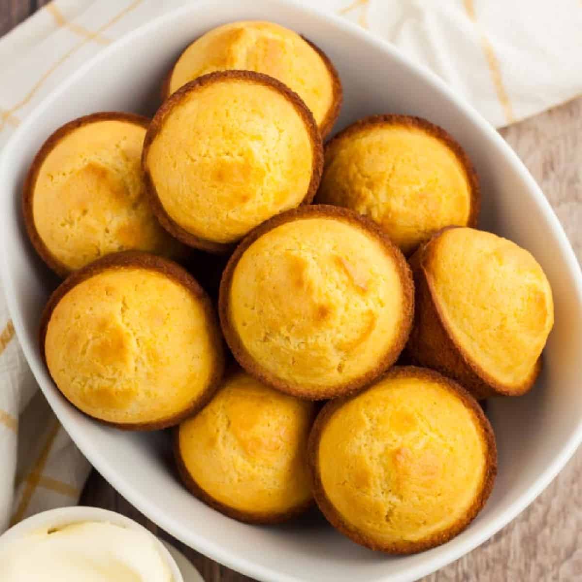 Cornbread Muffins are just so easy to make and much better than those store bought mixes. This cornbread muffin recipe is delicious and a family favorite. bowl of corn muffins